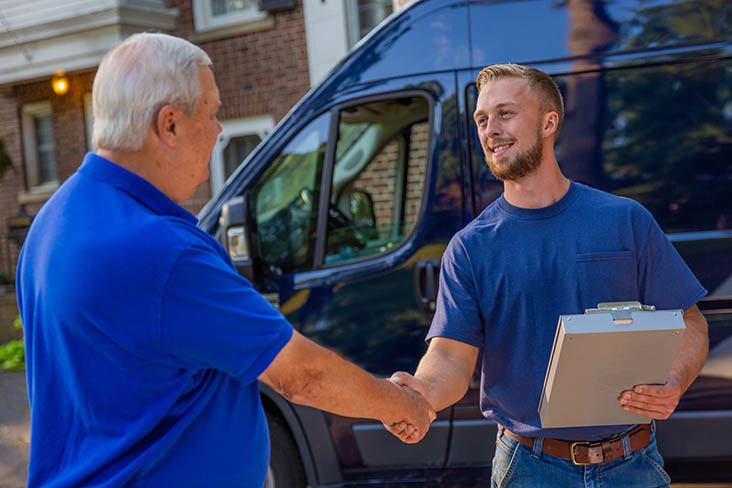 service technician shaking hands with a home owner